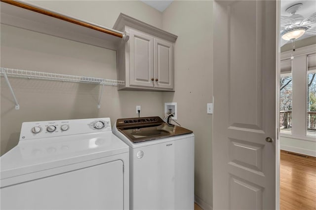 laundry room featuring visible vents, baseboards, washing machine and dryer, light wood-style floors, and cabinet space