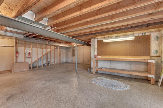 unfinished basement featuring electric panel