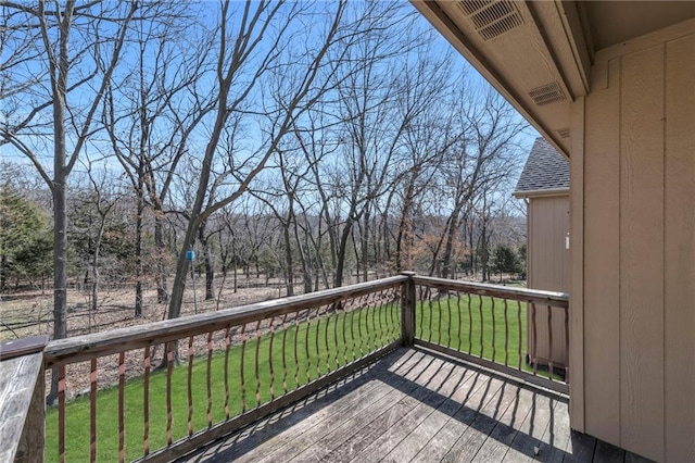 wooden terrace with a lawn