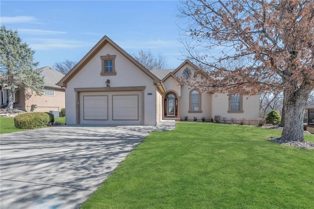 view of front of property featuring a front lawn, a garage, driveway, and stucco siding