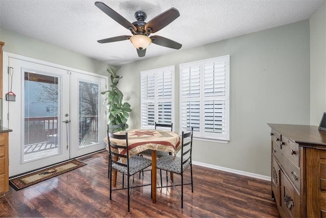 dining room featuring dark wood-type flooring, ceiling fan, french doors, and a textured ceiling