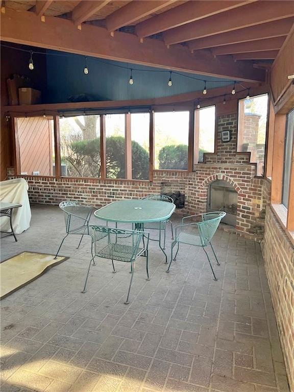view of patio / terrace featuring an outdoor brick fireplace and outdoor dining space