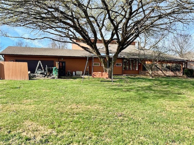 back of property featuring a lawn, a chimney, and a sunroom