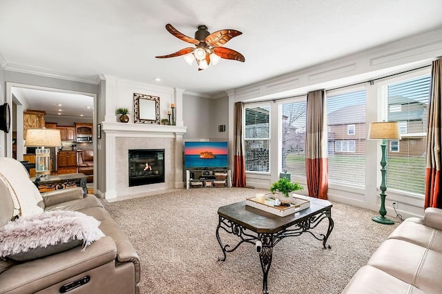 living room with ornamental molding, light carpet, ceiling fan, and a fireplace