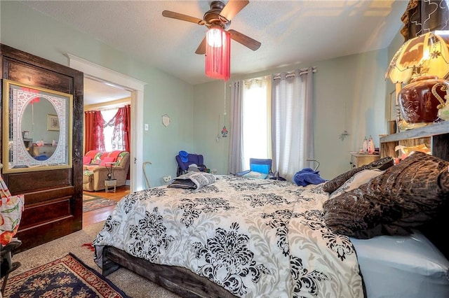 bedroom featuring multiple windows, wood-type flooring, and ceiling fan