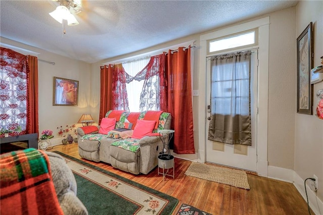 living room featuring plenty of natural light, hardwood / wood-style floors, and a textured ceiling