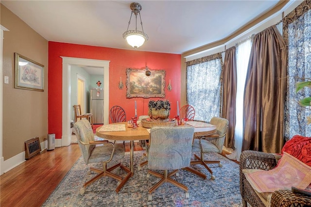 dining room with hardwood / wood-style flooring