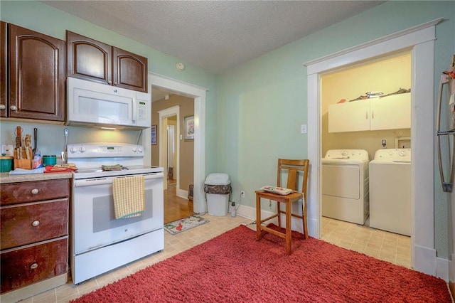 kitchen featuring dark brown cabinets, a textured ceiling, light tile patterned floors, white appliances, and washing machine and dryer