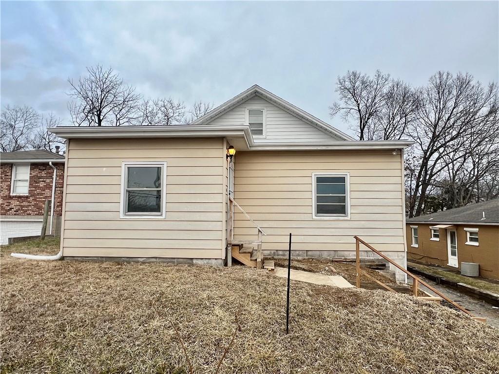 rear view of property with central AC