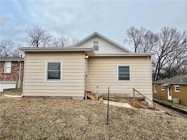 rear view of property with central AC