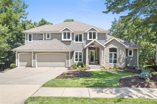 view of front of house with roof with shingles, a garage, stone siding, driveway, and a front lawn