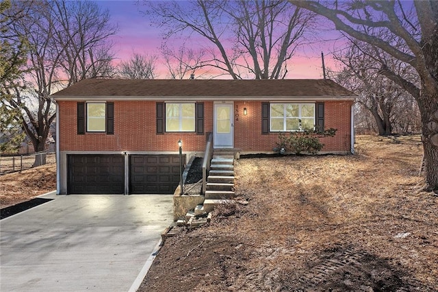 ranch-style home featuring brick siding, driveway, and an attached garage