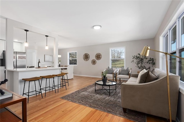 living room featuring light wood-style flooring and baseboards