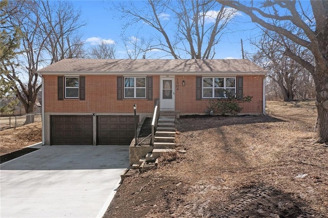 ranch-style house with a garage, concrete driveway, and brick siding