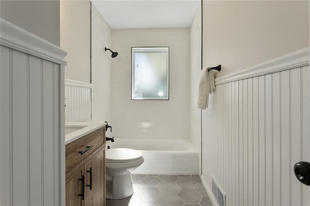 bathroom with visible vents, toilet, vanity,  shower combination, and tile patterned floors