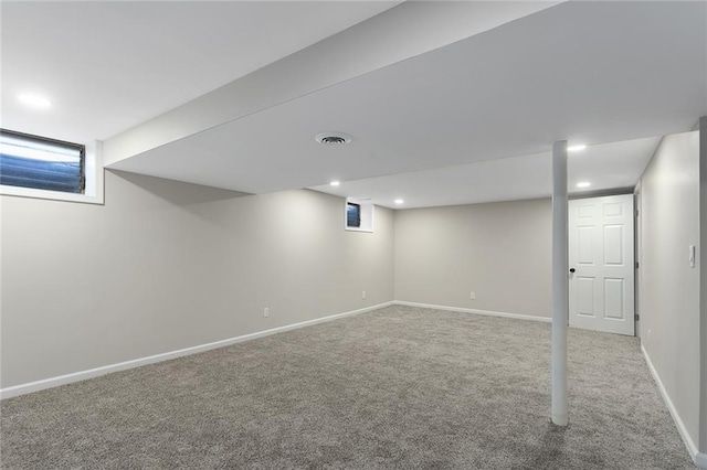 finished below grade area featuring recessed lighting, carpet, visible vents, and baseboards