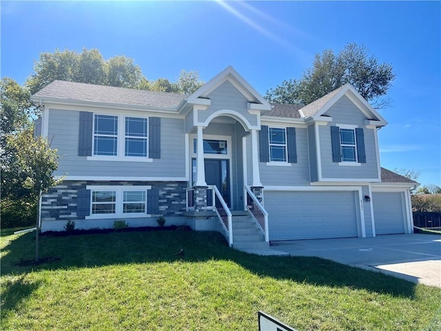 bi-level home with a garage and a front yard