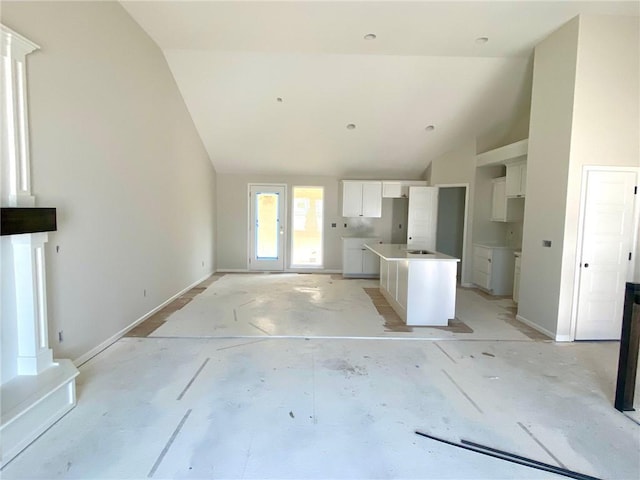 1103 Noah Ln, Kearney, MO 64060 - unfurnished living room featuring baseboards and high vaulted ceiling