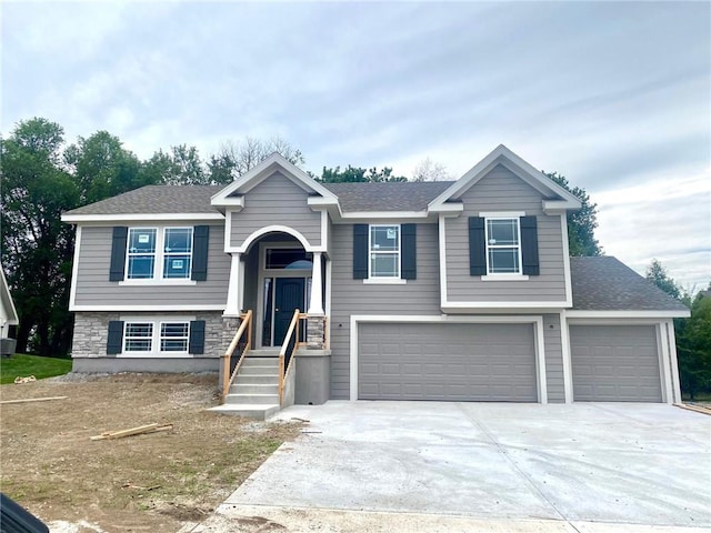 1103 Noah Ln, Kearney, MO 64060 - raised ranch with a garage, driveway, and stone siding