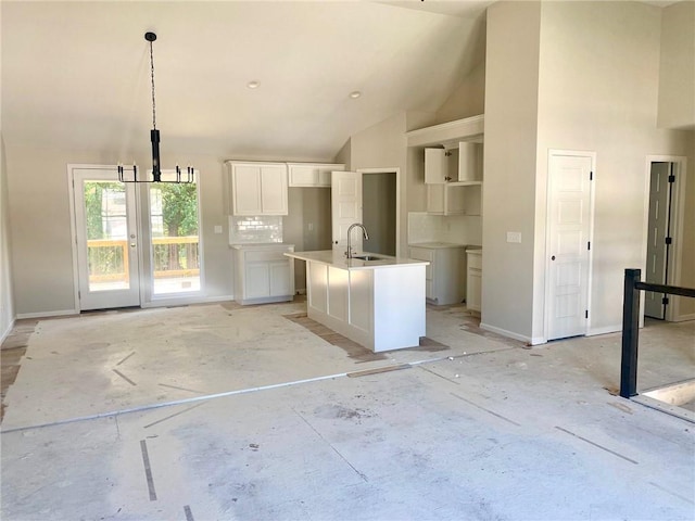 1103 Noah Ln, Kearney, MO 64060 - kitchen with white cabinetry, a center island with sink, pendant lighting, high vaulted ceiling, and backsplash