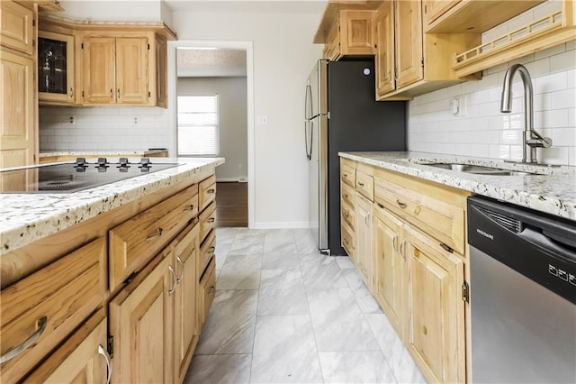 kitchen featuring light stone counters, sink, stainless steel appliances, and light brown cabinets