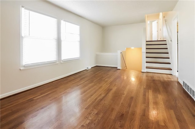 unfurnished living room with dark hardwood / wood-style flooring