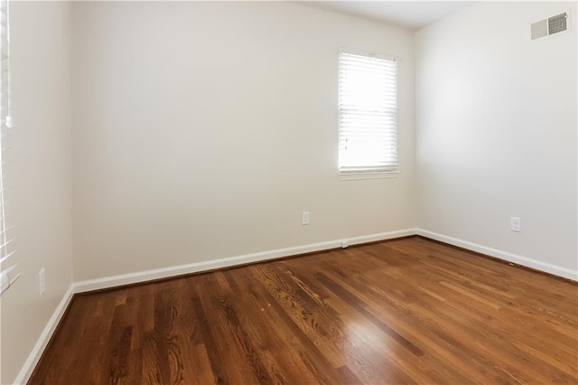 spare room featuring dark hardwood / wood-style floors