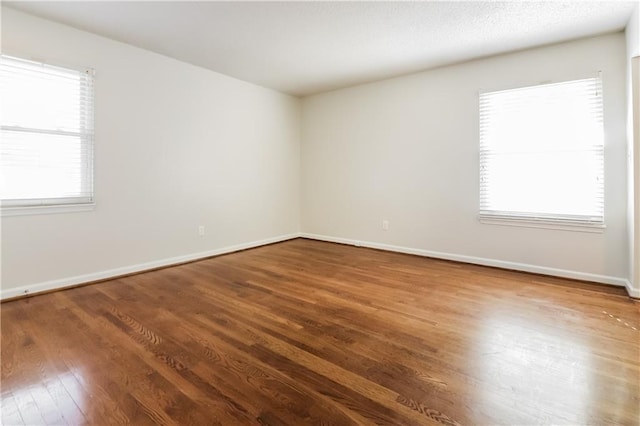 spare room with hardwood / wood-style floors