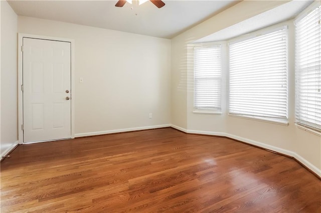 unfurnished room with ceiling fan and hardwood / wood-style floors