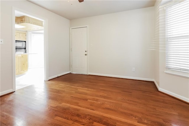 unfurnished room featuring ceiling fan and wood-type flooring