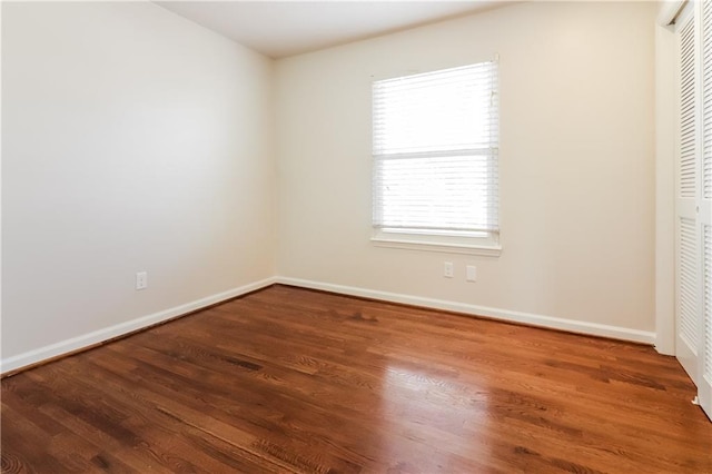 interior space with dark hardwood / wood-style flooring and a closet