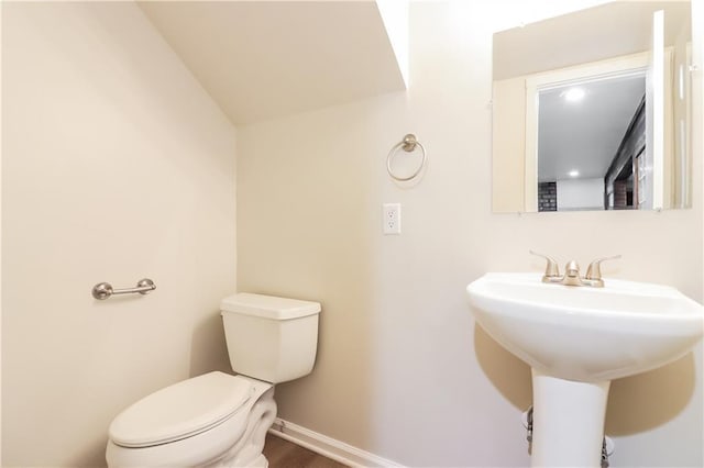 bathroom with sink, hardwood / wood-style floors, and toilet