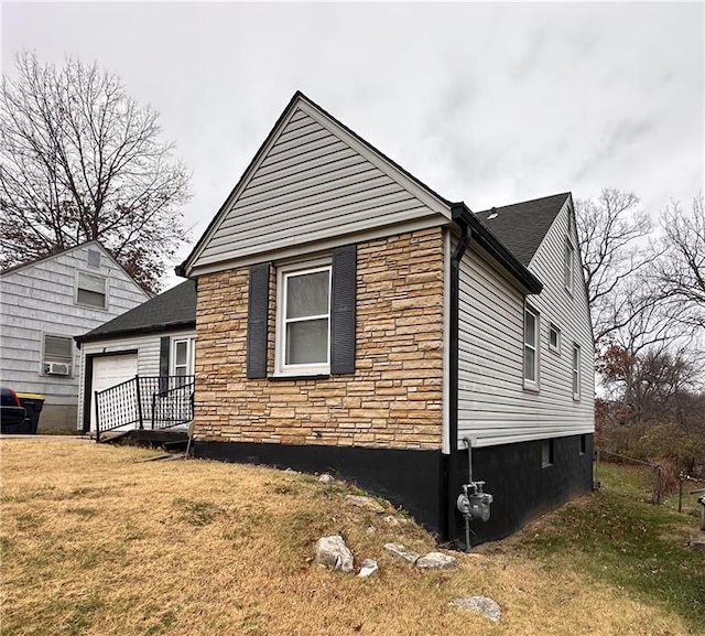 view of side of home with a yard and a garage