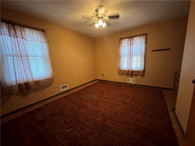 carpeted spare room with ceiling fan