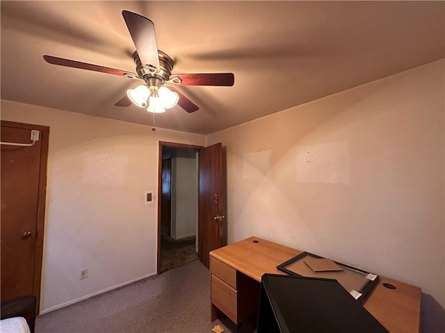 home office with ceiling fan and dark colored carpet