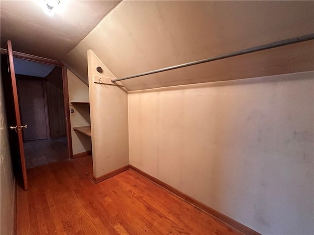 spacious closet featuring wood-type flooring and vaulted ceiling