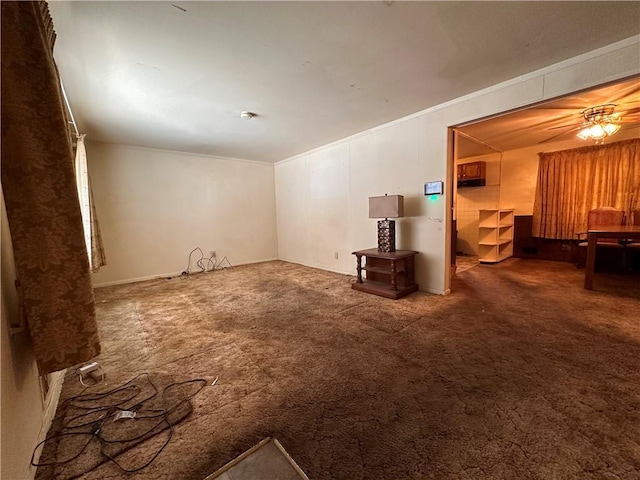 spare room with crown molding, ceiling fan, and carpet flooring