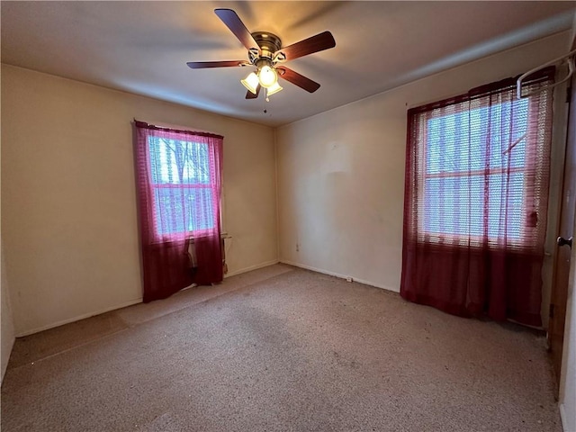 carpeted spare room with ceiling fan