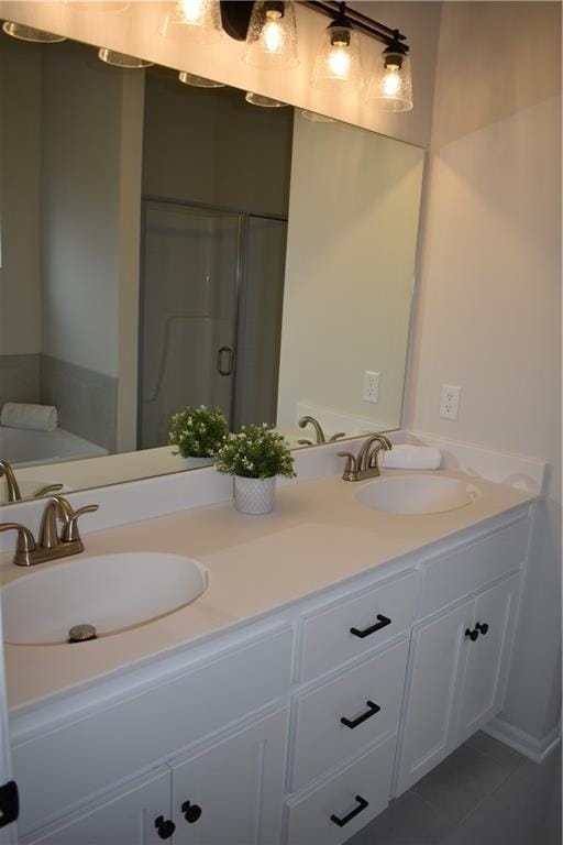 bathroom featuring tile patterned flooring, vanity, and walk in shower