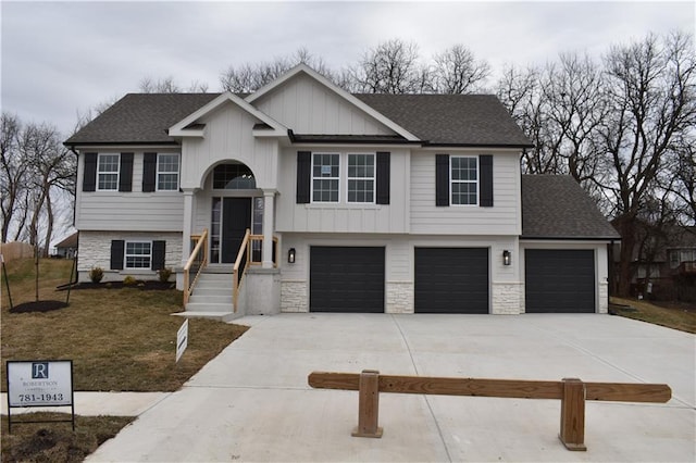 split foyer home with a garage and a front lawn