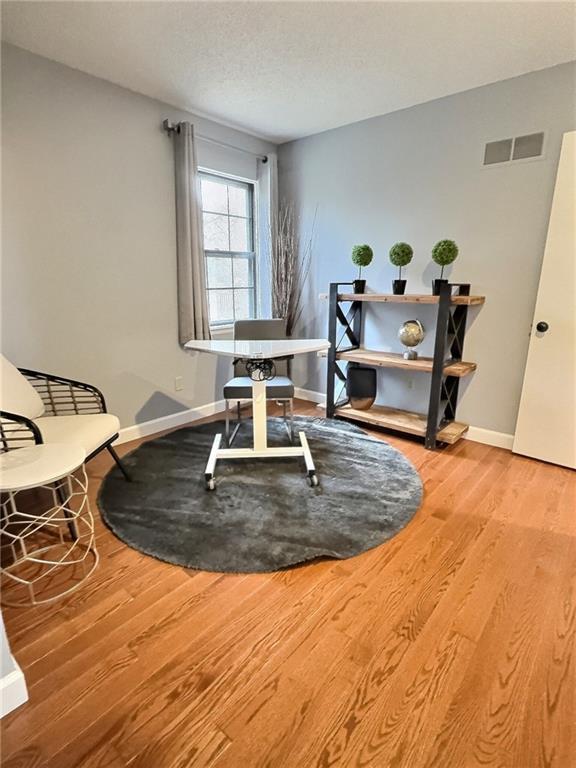 interior space featuring hardwood / wood-style flooring and a textured ceiling