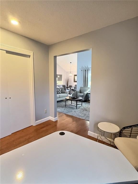 bedroom featuring hardwood / wood-style flooring and a textured ceiling