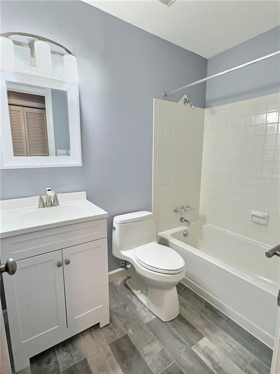 full bathroom featuring vanity, wood-type flooring, shower / bathtub combination, and toilet