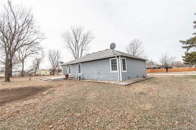 view of property exterior featuring central AC and a yard