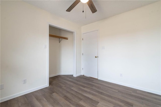 unfurnished bedroom featuring ceiling fan, dark hardwood / wood-style flooring, and a closet