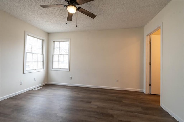 unfurnished room featuring ceiling fan, dark wood-type flooring, and a textured ceiling