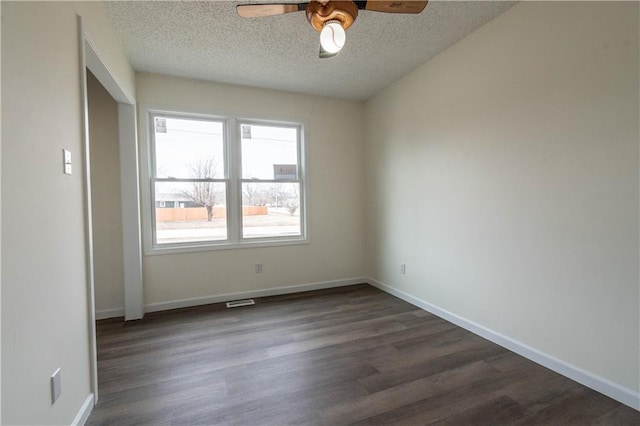 unfurnished room with ceiling fan, dark hardwood / wood-style floors, and a textured ceiling