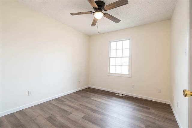 spare room with hardwood / wood-style floors, a textured ceiling, and ceiling fan