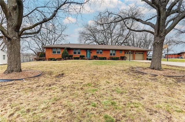 ranch-style home featuring a garage and a front lawn