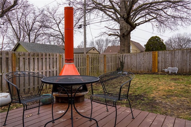 deck with a yard and a fire pit